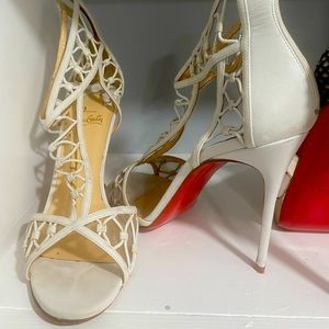 White Christian Louboutin sandals.